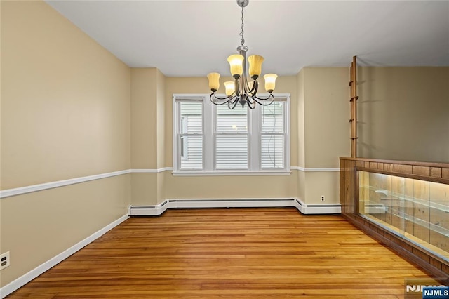115 12th St, Prospect Park, NJ 07508 - unfurnished dining area featuring a chandelier and wood finished floors