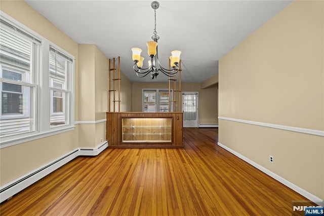 115 12th St, Prospect Park, NJ 07508 - unfurnished living room with a chandelier, a baseboard radiator, and wood finished floors