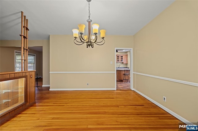 115 12th St, Prospect Park, NJ 07508 - unfurnished dining area with light wood finished floors and a chandelier
