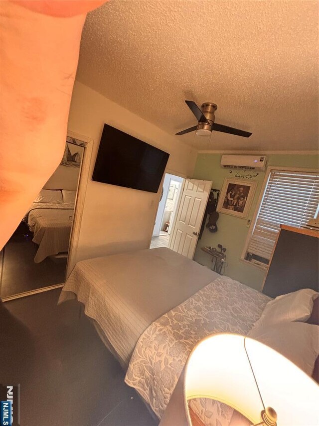 188 Hoyt St, Kearny, NJ 07032 - bedroom with a textured ceiling, ceiling fan, an AC wall unit, and carpet