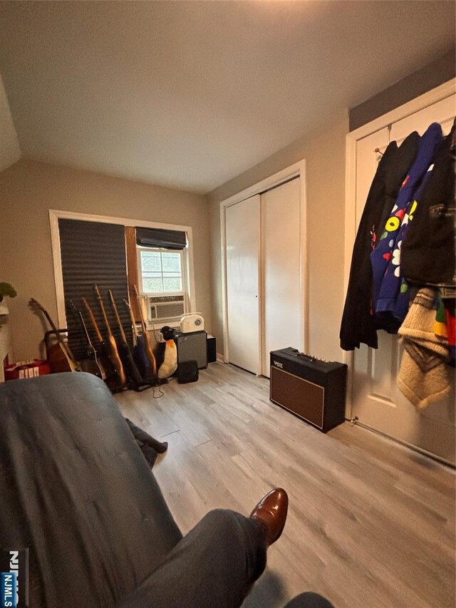 188 Hoyt St, Kearny, NJ 07032 - living room featuring light wood-style flooring, cooling unit, and vaulted ceiling