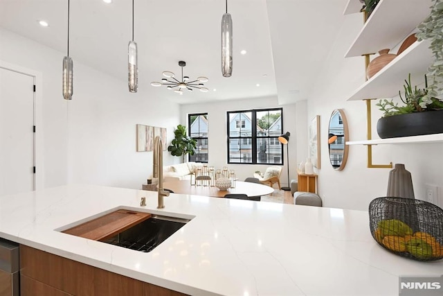 29 Armstrong Ave Unit 3, Jersey City, NJ 07305 - kitchen with open floor plan, recessed lighting, light stone countertops, pendant lighting, and open shelves
