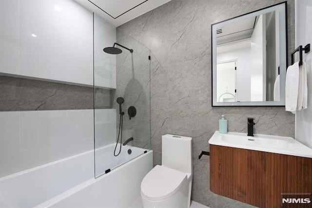 29 Armstrong Ave Unit 3, Jersey City, NJ 07305 - bathroom featuring tile walls, vanity, and  shower combination