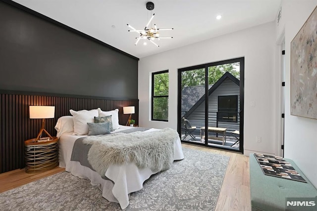 29 Armstrong Ave Unit 3, Jersey City, NJ 07305 - bedroom with a chandelier, wood finished floors, access to outside, and recessed lighting