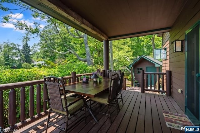 19 Division Ln, Byram, NJ 07821 - wooden terrace featuring outdoor dining area and an outbuilding