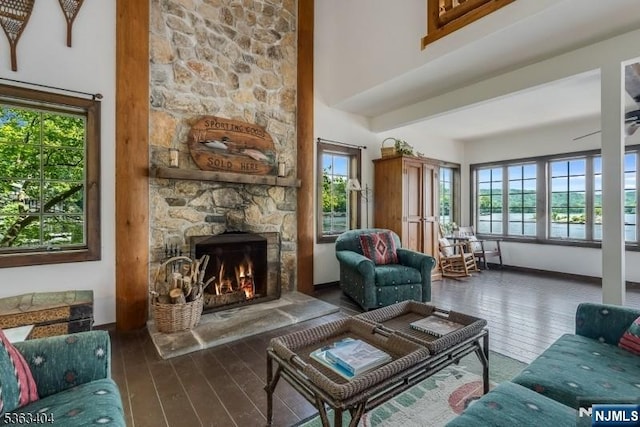 19 Division Ln, Byram, NJ 07821 - living area with wood-type flooring, plenty of natural light, a fireplace, and a high ceiling