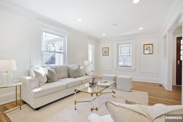 46 Oak Ridge Ave, Nutley, NJ 07110 - living area featuring crown molding, plenty of natural light, wood finished floors, a decorative wall, and decorative columns