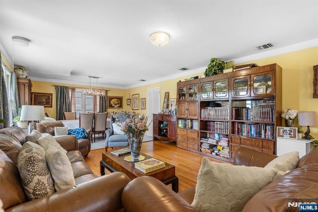 8 Hampton Rd, Clifton, NJ 07012 - living room featuring a chandelier, ornamental molding, and light wood finished floors