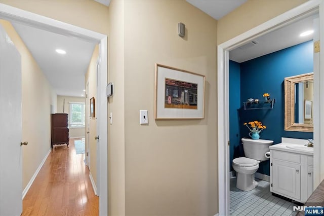 206 Wind Hollow Ct, Mahwah, NJ 07430 - hallway featuring a sink and light wood-style flooring