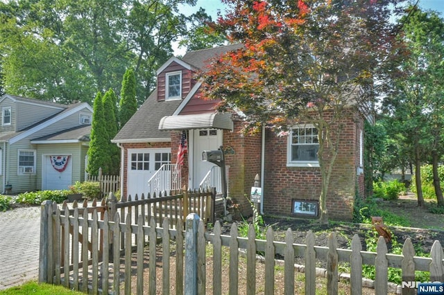 36 Grove St, Waldwick, NJ 07463 - view of front of house with brick siding, a garage, roof with shingles, and driveway