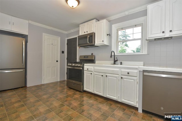 36 Grove St, Waldwick, NJ 07463 - kitchen with stainless steel appliances, light countertops, white cabinets, backsplash, and ornamental molding