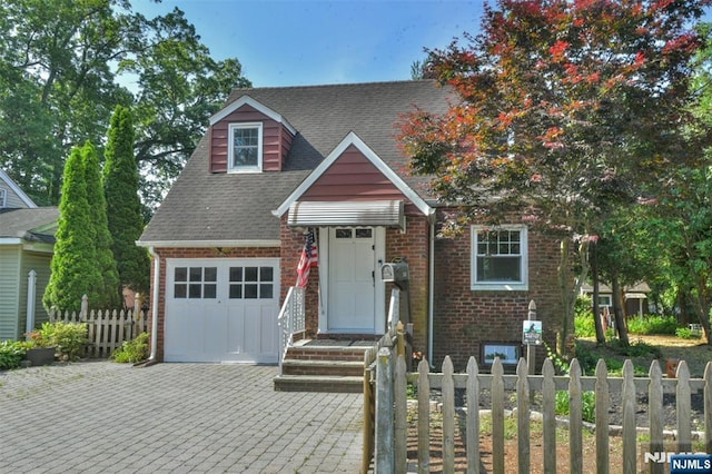 36 Grove St, Waldwick, NJ 07463 - view of front of property with brick siding, driveway, an attached garage, and a shingled roof