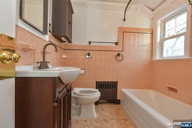 36 Grove St, Waldwick, NJ 07463 - bathroom featuring radiator heating unit, tile walls, a tub to relax in, vanity, and tile patterned floors