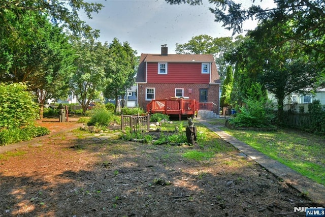 36 Grove St, Waldwick, NJ 07463 - back of property with a deck, a chimney, and brick siding