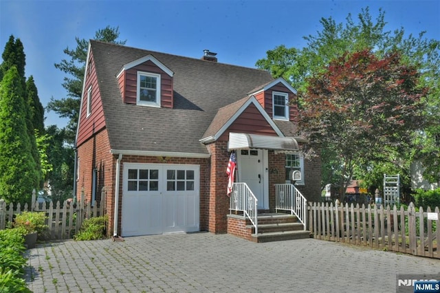 36 Grove St, Waldwick, NJ 07463 - view of front of home featuring brick siding, decorative driveway, roof with shingles, and a chimney