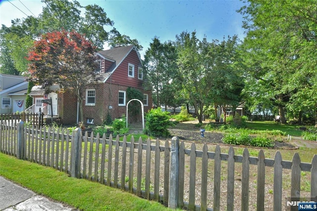 36 Grove St, Waldwick, NJ 07463 - view of front facade with brick siding and a fenced front yard