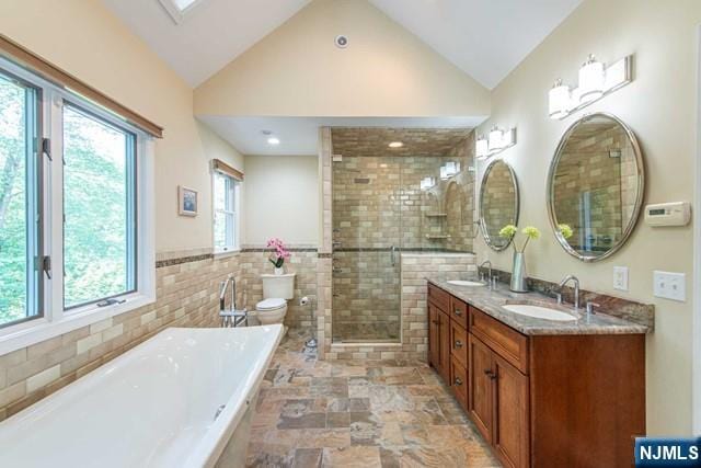 5 Hurley Ct, Wyckoff, NJ 07481 - full bath featuring a tub to relax in, double vanity, vaulted ceiling, tiled shower, and tile walls