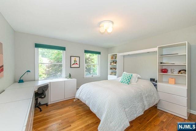 5 Hurley Ct, Wyckoff, NJ 07481 - bedroom with light wood-type flooring and an office area