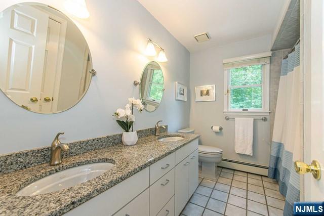 5 Hurley Ct, Wyckoff, NJ 07481 - full bathroom featuring a baseboard radiator, double vanity, tile patterned flooring, and a shower with shower curtain