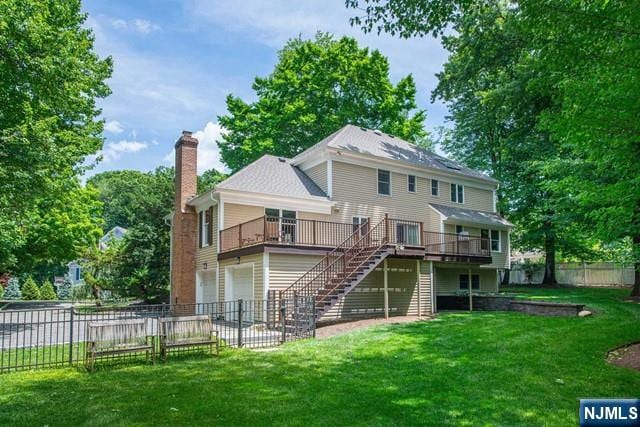 5 Hurley Ct, Wyckoff, NJ 07481 - rear view of house with a chimney, stairs, a fenced backyard, a deck, and an attached garage