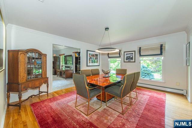 5 Hurley Ct, Wyckoff, NJ 07481 - dining space with baseboard heating, wood finished floors, and ornamental molding