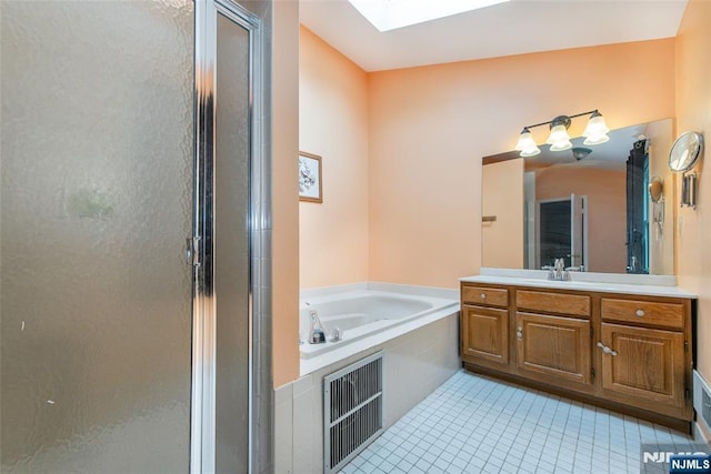 76 Point View Parkway, Wayne, NJ 07470 - full bathroom with vanity, a shower stall, a skylight, tile patterned floors, and a garden tub