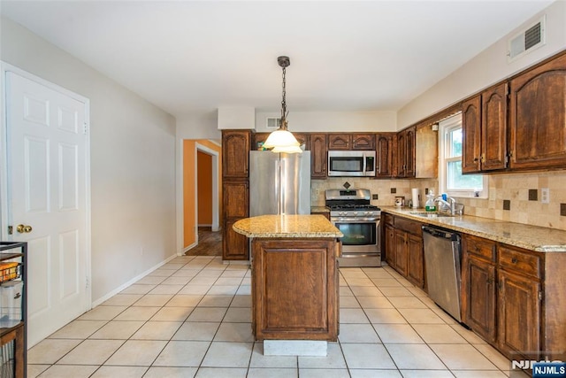 76 Point View Parkway, Wayne, NJ 07470 - kitchen featuring stainless steel appliances, a center island, decorative backsplash, and light tile patterned flooring