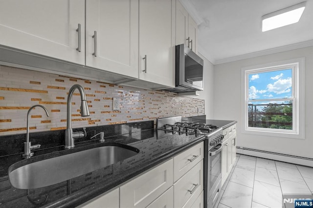 8829 Kennedy Blvd Unit E5, North Bergen, NJ 07047 - kitchen featuring stainless steel appliances, a baseboard radiator, light marble finish floors, white cabinets, and ornamental molding