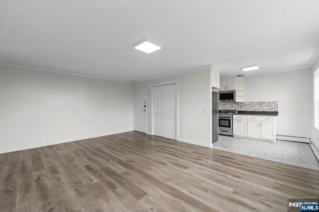 8829 Kennedy Blvd Unit E5, North Bergen, NJ 07047 - unfurnished living room featuring crown molding, light wood finished floors, and baseboard heating