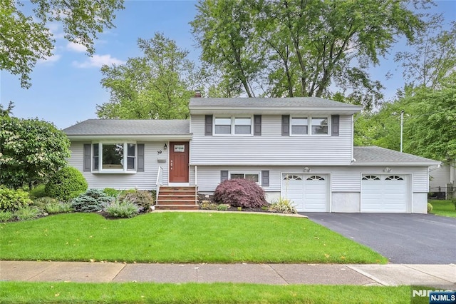 39 Terrace Rd, Wayne, NJ 07470 - split level home with asphalt driveway, a front yard, a chimney, and an attached garage