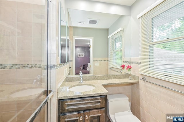 39 Terrace Rd, Wayne, NJ 07470 - full bathroom with tile walls, vanity, connected bathroom, and a shower stall