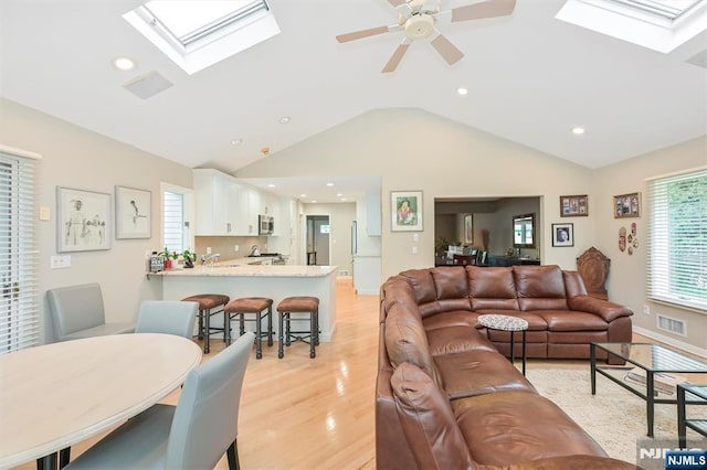 39 Terrace Rd, Wayne, NJ 07470 - living area featuring a skylight, lofted ceiling, light wood finished floors, recessed lighting, and a ceiling fan