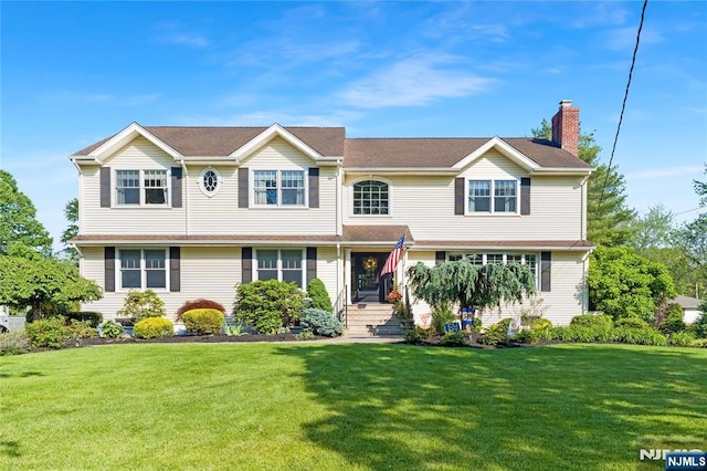 17 Windham Pl, Glen Rock, NJ 07452 - view of front of house featuring a chimney and a front yard