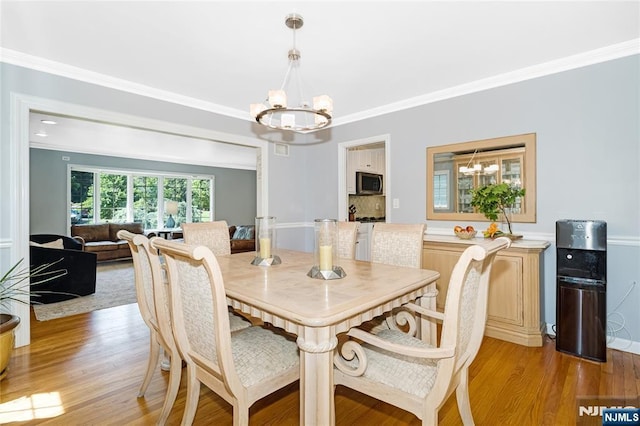 17 Windham Pl, Glen Rock, NJ 07452 - dining space featuring a chandelier, light wood-type flooring, and crown molding
