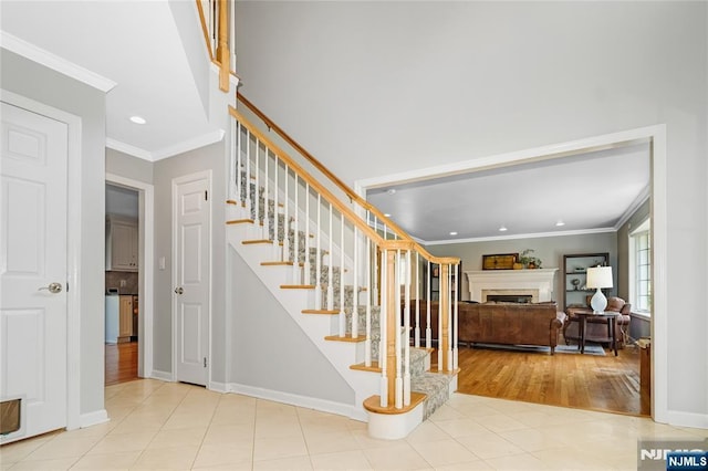 17 Windham Pl, Glen Rock, NJ 07452 - stairs featuring ornamental molding, recessed lighting, a fireplace, and wood finished floors