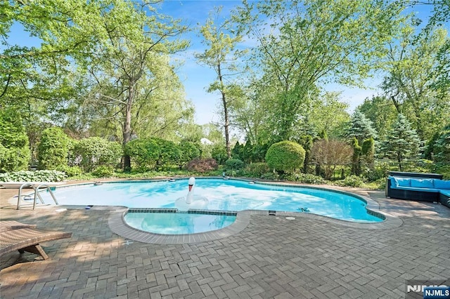 17 Windham Pl, Glen Rock, NJ 07452 - view of swimming pool with a pool with connected hot tub, a patio area, and view of wooded area