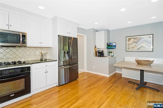 17 Windham Pl, Glen Rock, NJ 07452 - kitchen featuring stainless steel appliances, white cabinetry, tasteful backsplash, light wood-style flooring, and recessed lighting