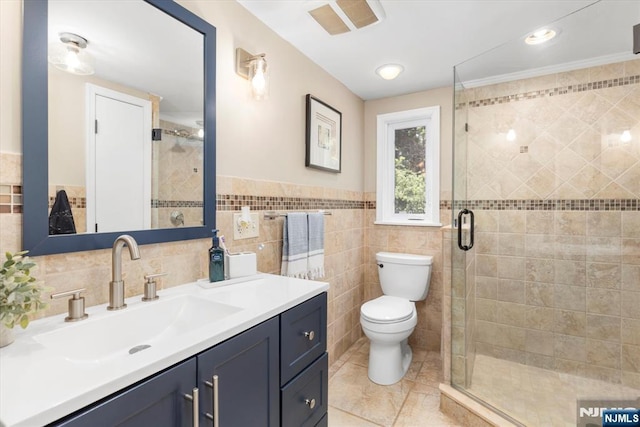 39 Division Ave, Hasbrouck Heights, NJ 07604 - bathroom featuring tile walls, vanity, tile patterned floors, a stall shower, and a wainscoted wall