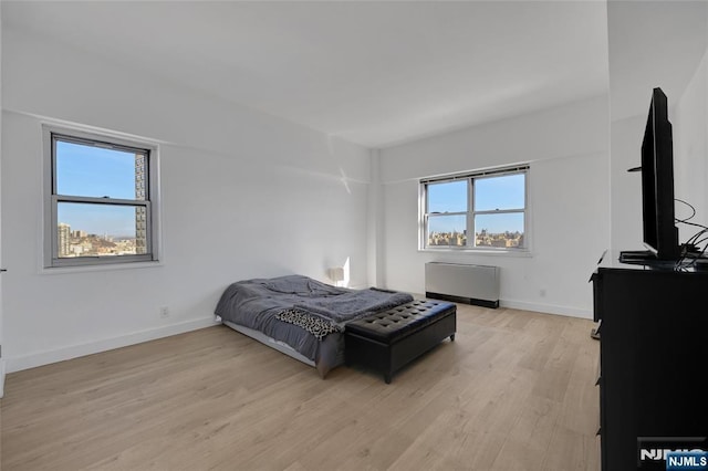 6600 Jfk Blvd E Unit 23L, West New York, NJ 07093 - bedroom featuring light wood-style flooring and radiator heating unit