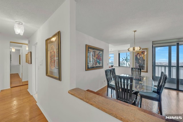 300 Winston Unit 2105, Cliffside Park, NJ 07010 - dining room featuring a textured ceiling, a chandelier, and light wood-type flooring