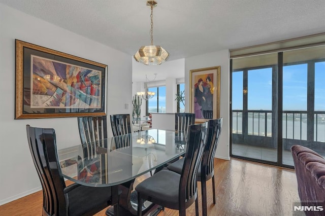 300 Winston Unit 2105, Cliffside Park, NJ 07010 - dining space featuring a chandelier, wood finished floors, a textured ceiling, and a water view