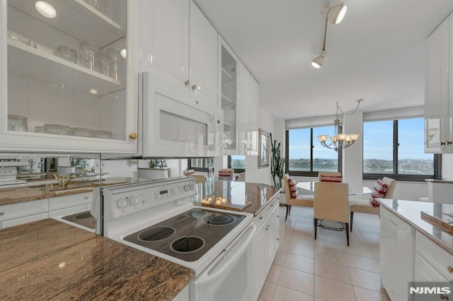 300 Winston Unit 2105, Cliffside Park, NJ 07010 - kitchen with white appliances, white cabinetry, dark stone counters, and a chandelier