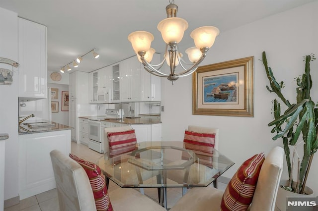300 Winston Unit 2105, Cliffside Park, NJ 07010 - dining area with a chandelier, light tile patterned floors, and rail lighting