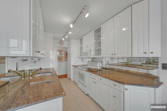300 Winston Unit 2105, Cliffside Park, NJ 07010 - kitchen featuring white appliances, white cabinets, light tile patterned floors, glass insert cabinets, and stone countertops