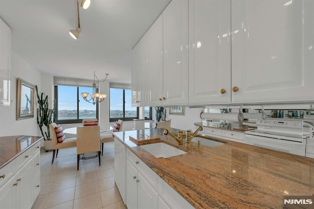 300 Winston Unit 2105, Cliffside Park, NJ 07010 - kitchen with white electric range oven, a chandelier, white cabinets, and stone countertops