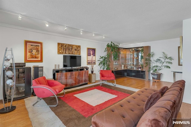 300 Winston Unit 2105, Cliffside Park, NJ 07010 - living room with wood finished floors, a textured ceiling, and rail lighting
