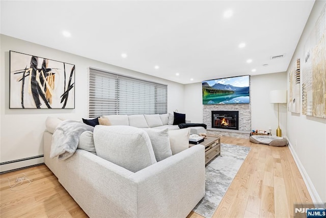 15 Kings Ct, Woodcliff Lake, NJ 07677 - living area with a baseboard radiator, wood finished floors, a stone fireplace, and recessed lighting