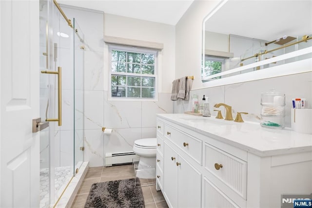 15 Kings Ct, Woodcliff Lake, NJ 07677 - bathroom with baseboard heating, tile walls, vanity, a marble finish shower, and healthy amount of natural light