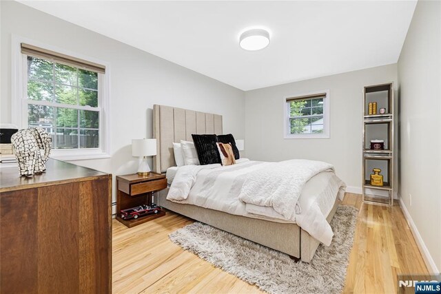 15 Kings Ct, Woodcliff Lake, NJ 07677 - bedroom featuring light wood finished floors and a baseboard heating unit