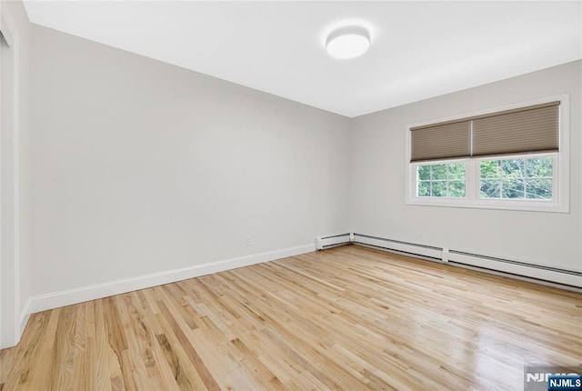 15 Kings Ct, Woodcliff Lake, NJ 07677 - empty room featuring wood finished floors and a baseboard heating unit